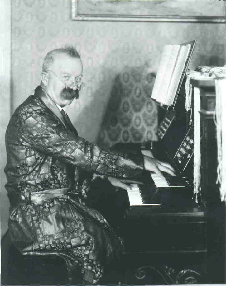 Mustachioed organist at Estey console